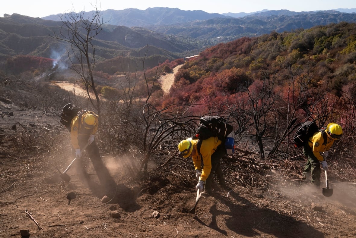 Firefighters from Mexico cut a containment line in the Tarzana area during the Palisades Fire in Los Angeles, Calif. on Jan. 13, 2025.