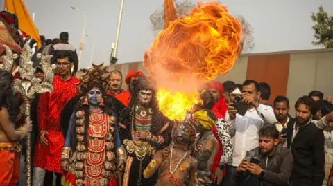 Ankit Srinivas Devotees performing fire rituals while entering the festival