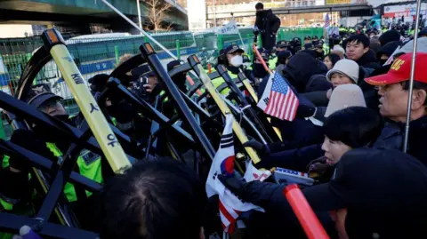 Reuters Yoon Suk Yeol's supporters scuffle with police officers as authorities seek to execute an arrest warrant on Wednesday morning.